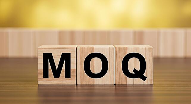 Wooden blocks displaying MOQ on a wooden surface with a blurred yellow background representing Minimum Order Quantity in business and trade conveying a sense of clarity and importance photo