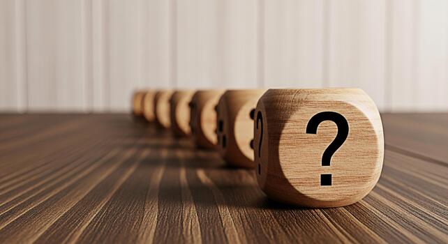 A row of wooden dice displaying question marks on a wooden table symbolizing uncertainty and the search for answers in a bright minimalist setting creating a thoughtful and inquisitive mood photo