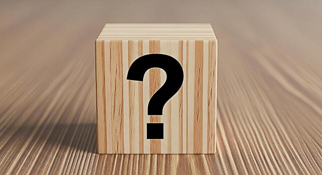 Wooden cube displaying a question mark on a textured wooden surface symbolizing uncertainty and the search for answers in a natural and simple setting evoking curiosity and problemsolving photo