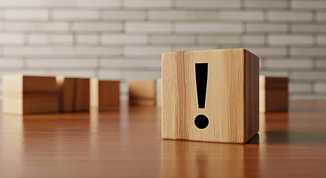 Prominent wooden block displaying an exclamation point on a polished wooden surface symbolizing urgency and attention to detail in a minimalist and clean environment with a brick wall background photo