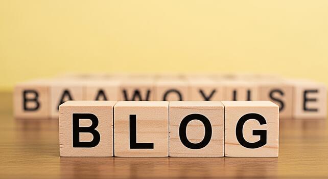 Wooden blocks spelling BLOG on a wooden surface against a yellow background representing the concept of blogging online content creation and the importance of digital communication in a modern world photo