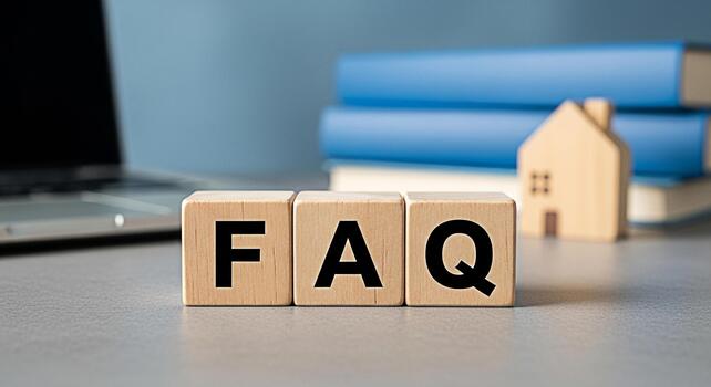 FAQ wooden blocks displayed on a desk with a laptop and a wooden house model representing frequently asked questions about real estate and property investment in a modern and informative setting photo