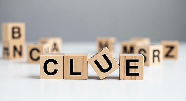 Wooden blocks spelling out CLUE on a white surface creating a sense of mystery and intrigue perfect for educational games problemsolving activities and promoting critical thinking skills in a playful photo