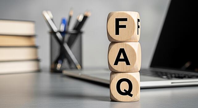 Wooden FAQ blocks stacked on a desk in a modern office setting representing frequently asked questions and providing information and support to customers with a clear and concise message photo