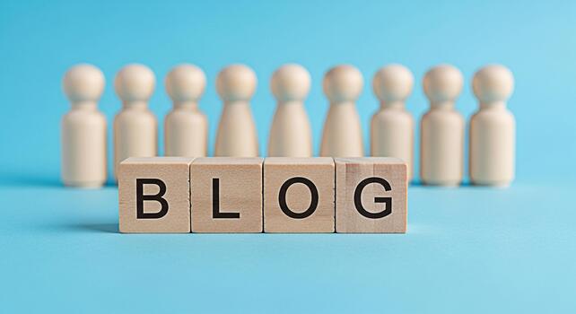 Wooden blocks spelling BLOG stand prominently in front of a group of wooden figures on a light blue background representing community connection and the power of online communication photo