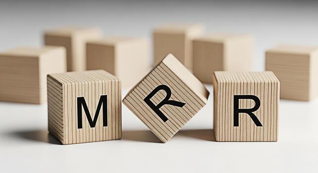 Wooden blocks displaying MRR on a white surface symbolizing Monthly Recurring Revenue in a business setting conveying a sense of financial growth stability and the importance of recurring income photo
