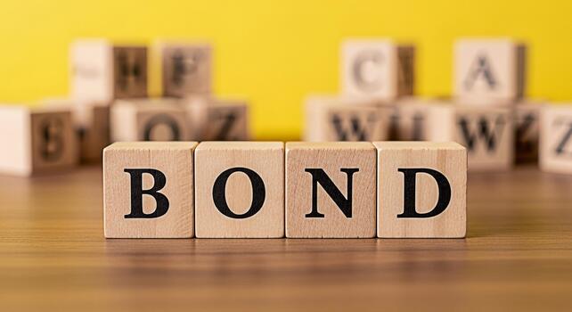 Wooden blocks spelling BOND on a wooden surface against a yellow background representing financial security investment and the concept of unity and connection in a bright and optimistic setting photo