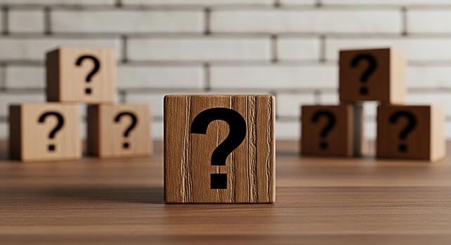 Wooden blocks displaying question marks sitting on a wooden table against a white brick wall symbolizing uncertainty and the need for answers in a complex and challenging situation photo