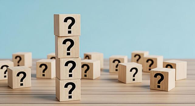Stacked wooden blocks displaying question marks on a wooden surface against a blue background representing uncertainty problemsolving and the search for answers in a conceptual and thoughtprovoking co photo