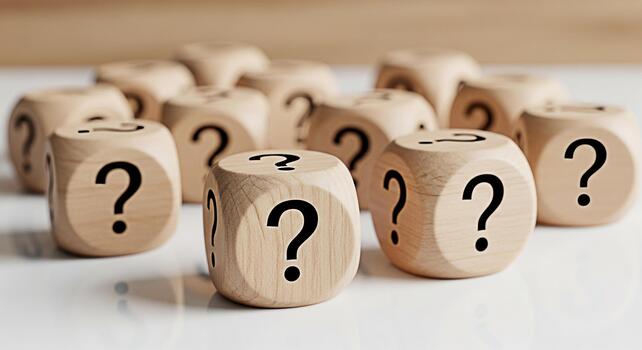 Group of wooden dice displaying question marks on a white surface representing uncertainty and the need for answers in a complex situation creating a mood of curiosity and inquiry photo