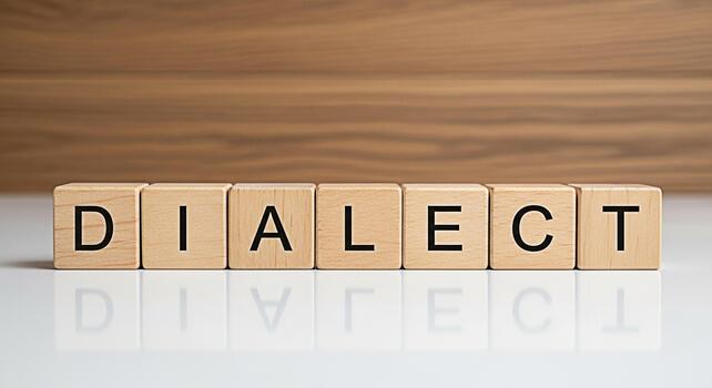 Wooden blocks spelling DIALECT on a reflective surface against a woodpatterned background representing language diversity and cultural communication in a studio setting conveying a message of understa photo