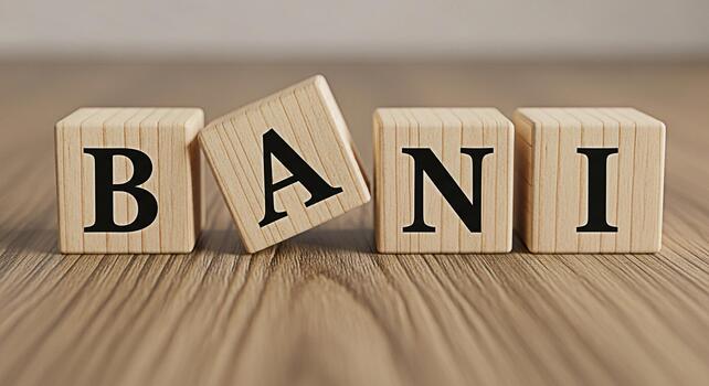 Wooden blocks spelling BANI on a wooden surface with the A block tilted creating a playful and educational atmosphere for learning alphabets and language skills promoting early childhood development photo
