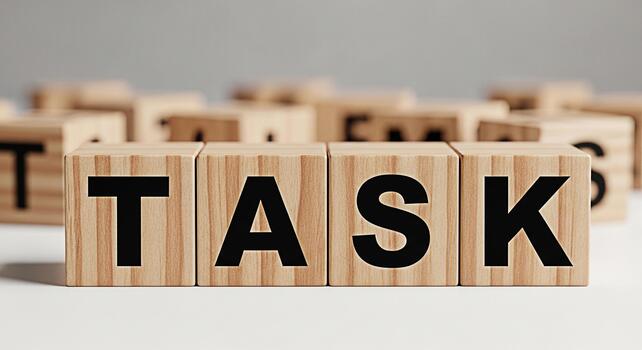 Wooden blocks spelling out TASK on a white surface representing project management and workload organization in a minimalist and clean environment conveying a sense of focus and productivity photo