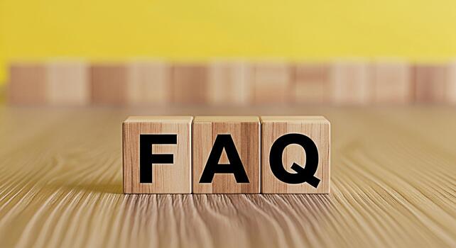 FAQ letters on wooden blocks displayed on a wooden table against a yellow background representing frequently asked questions and providing information and support with a clear and concise message photo