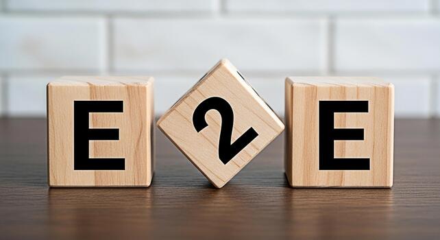 Wooden blocks displaying E2E on a wooden table against a white brick wall symbolizing endtoend process efficiency and streamlined workflow in a modern business environment photo