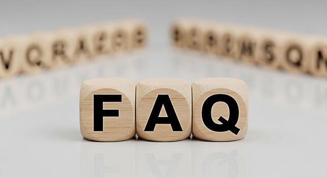 Wooden blocks displaying FAQ on a reflective surface representing frequently asked questions and information access in a clean minimalist setting conveying clarity and helpfulness photo