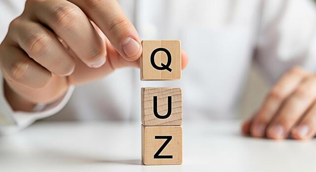 Person arranging wooden blocks spelling QUIZ on a white table symbolizing knowledge assessment and intellectual challenge in an educational environment promoting learning and cognitive skills photo