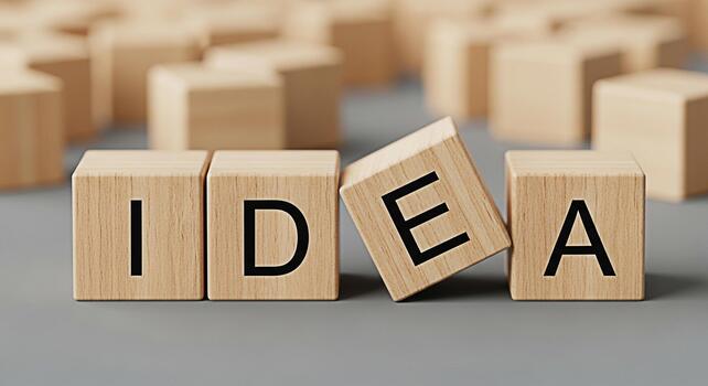 Wooden blocks spelling IDEA arranged creatively on a gray surface symbolizing innovation brainstorming and the generation of new concepts in a minimalist and thoughtprovoking setting photo