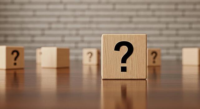 Wooden blocks displaying question marks on a reflective surface in a studio setting representing uncertainty inquiry and the search for answers in problemsolving and decisionmaking processes photo