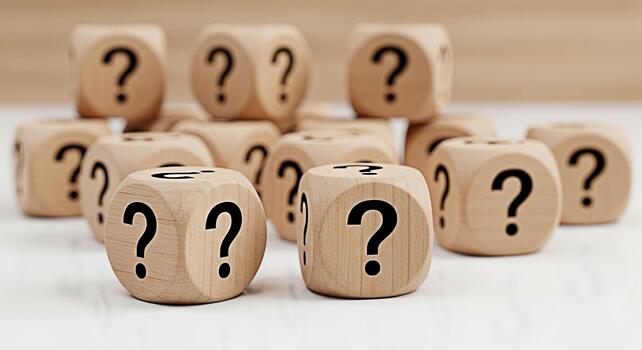 Pile of wooden dice displaying question marks on a white surface symbolizing uncertainty and the need for answers in a conceptual and inquisitive environment fostering curiosity and problemsolving photo
