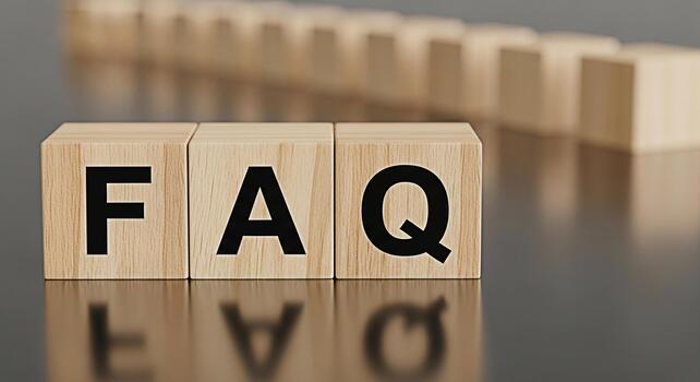 Wooden blocks displaying FAQ on a reflective surface representing frequently asked questions in a business or educational setting conveying clarity support and accessibility of information photo