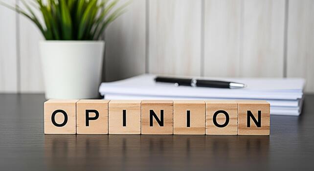 Wooden blocks spelling Opinion resting on a desk in a bright office setting symbolizing personal perspective and the importance of diverse viewpoints in decisionmaking and creative problemsolving photo