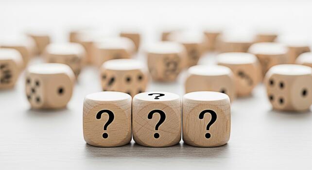 Three wooden dice displaying question marks on a neutral surface symbolizing uncertainty and the search for answers in a conceptual and thoughtprovoking composition ideal for business and education photo