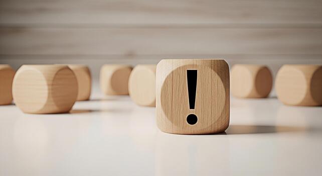 Prominent wooden block displaying an exclamation mark symbol standing out among other blocks on a bright surface symbolizing attention warning and the importance of problemsolving in a minimalist sett photo