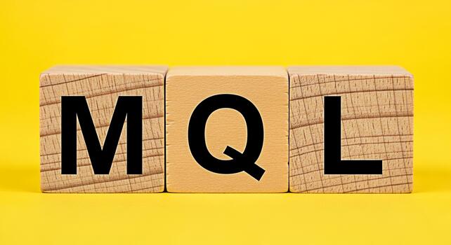 Wooden blocks displaying the letters MQL against a bright yellow background representing Marketing Qualified Leads and the concept of lead generation and marketing strategy in a simple eyecatching way photo