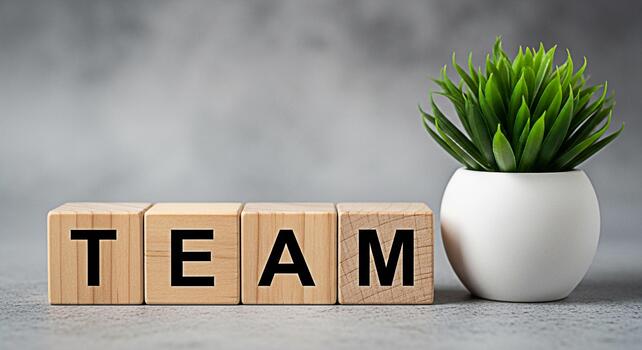 de madera bloques ortografía equipo desplegado en un gris superficie siguiente a un en conserva planta simbolizando colaboración unidad y el importancia de trabajo en equipo en lograr éxito y Fomentando un positivo trabajo reinar foto