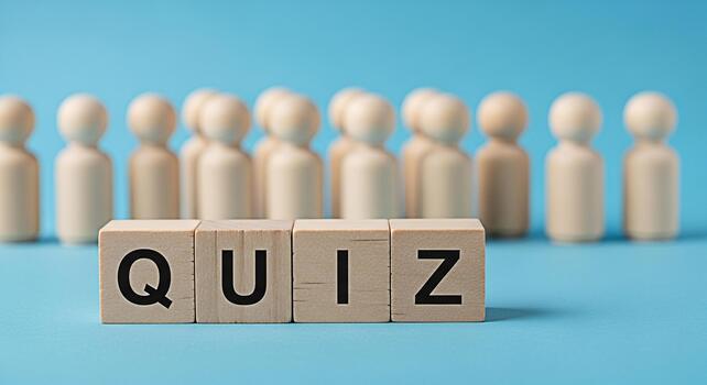 Wooden blocks spelling QUIZ stand prominently against a blue background with blurred wooden figures symbolizing participants creating a playful and engaging atmosphere for educational testing and know photo