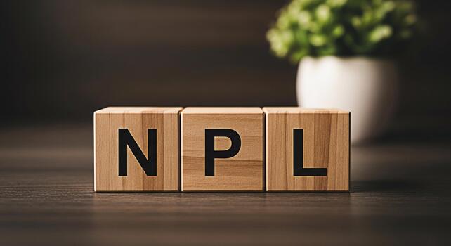 Wooden blocks displaying NPL on a dark wooden surface representing NonPerforming Loans in a financial setting conveying a serious and concerning business concept with a minimalist design photo