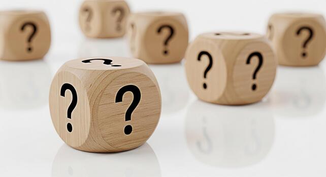 Wooden dice displaying question marks on a reflective white surface representing uncertainty confusion and the need for answers in decisionmaking and problemsolving scenarios photo