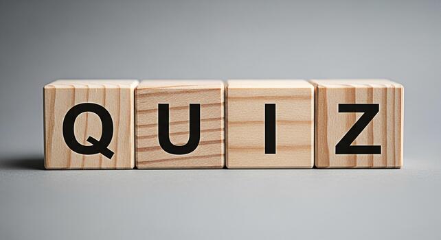 Wooden blocks spelling QUIZ on a gray surface representing a test of knowledge and skills in an educational setting evoking a sense of challenge and intellectual curiosity perfect for learning platfor photo