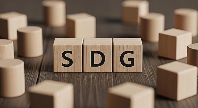 Wooden blocks spelling SDG resting on a dark wooden surface surrounded by other blocks symbolizing sustainable development goals and a commitment to global sustainability in a conceptual setting photo