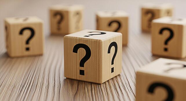 Wooden cubes displaying question marks on a textured wooden surface representing uncertainty and the need for answers in a conceptual and thoughtprovoking setting creating a sense of curiosity photo