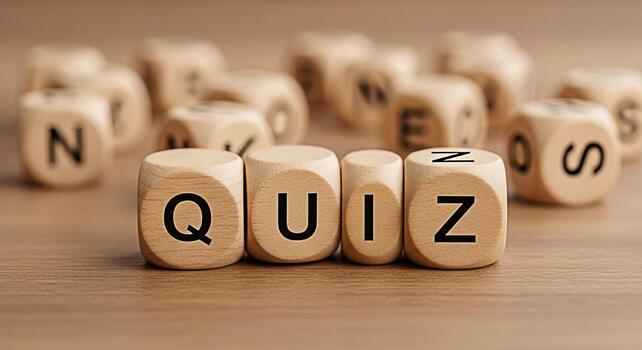 Wooden letter blocks spelling QUIZ on a wooden surface surrounded by blurred letter blocks representing knowledge testing and education in a warm inviting atmosphere photo