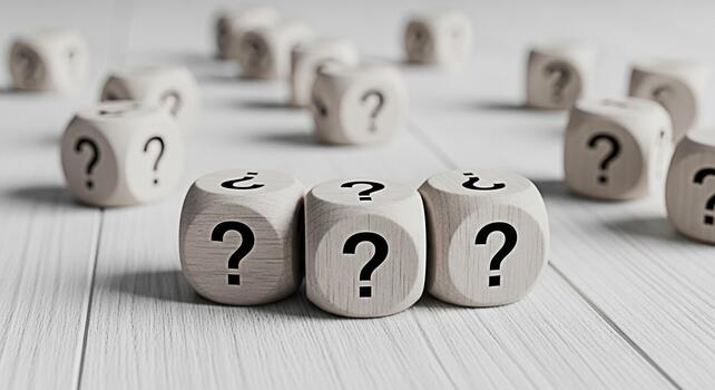 Wooden dice displaying question marks on a white wooden surface symbolizing uncertainty and the search for answers creating a mood of contemplation and curiosity in a minimalist setting photo
