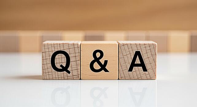 Wooden blocks displaying Q A on a white reflective surface representing questions and answers in a clear and concise manner fostering understanding and knowledge sharing photo