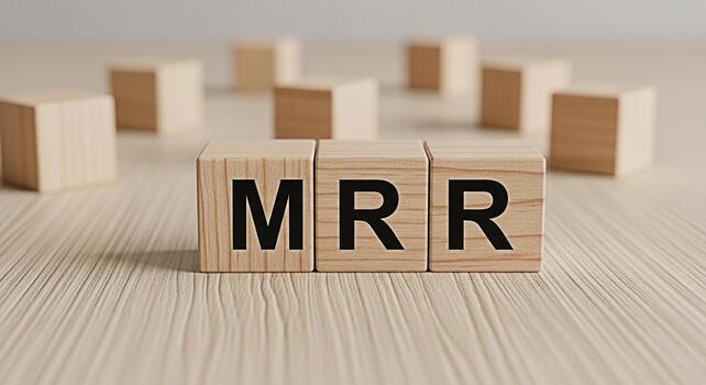 Wooden blocks displaying MRR on a wooden surface representing monthly recurring revenue in a business setting conveying a sense of financial stability and growth potential for subscriptionbased servic photo