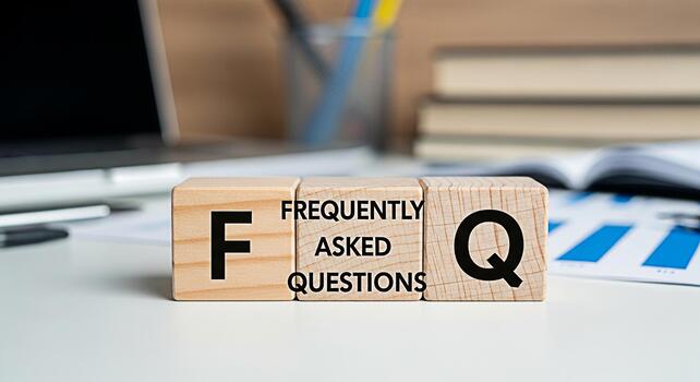 Wooden blocks displaying FAQ on a bright office desk with a laptop and documents symbolizing readily available information and customer support for a seamless user experience and increased satisfactio photo