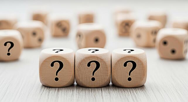 Wooden dice displaying question marks on a textured surface symbolizing uncertainty and the need for answers creating a sense of mystery and intrigue in a closeup studio shot photo