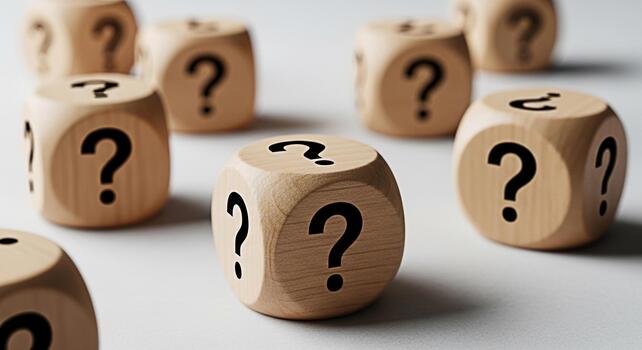 Wooden dice displaying question marks on a white surface representing uncertainty and the need for answers in a business context creating a sense of curiosity and problemsolving photo
