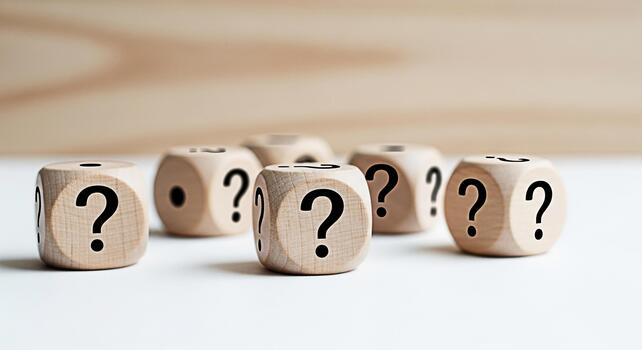 Wooden dice displaying question marks on a white surface representing uncertainty and the need for answers in a bright and minimalist environment symbolizing problemsolving and decisionmaking processe photo