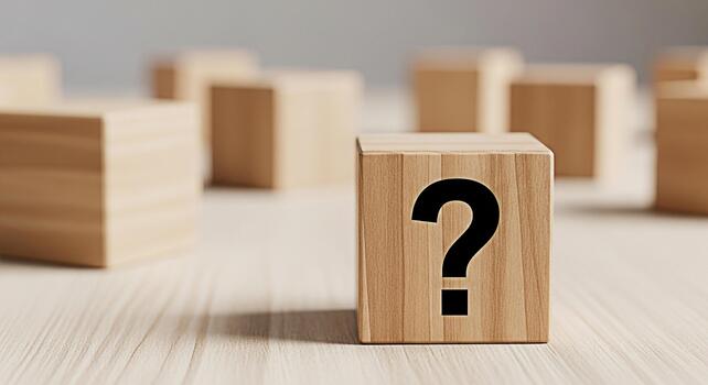Wooden cube displaying a question mark on a bright wooden surface surrounded by blurred cubes representing uncertainty curiosity and the search for answers in a minimalist and clean setting photo