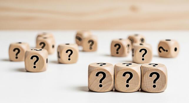 Wooden dice displaying question marks on a white surface symbolizing uncertainty and the search for answers in a minimalist and clean environment creating a mood of curiosity and inquiry photo