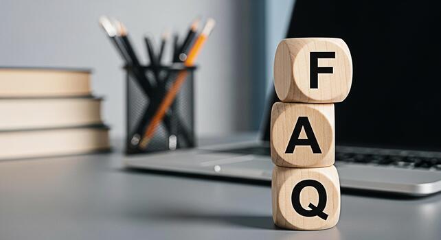 Wooden blocks displaying FAQ on a desk with a laptop and stationery representing information access and customer support in a modern office environment conveying a sense of helpfulness and clarity photo