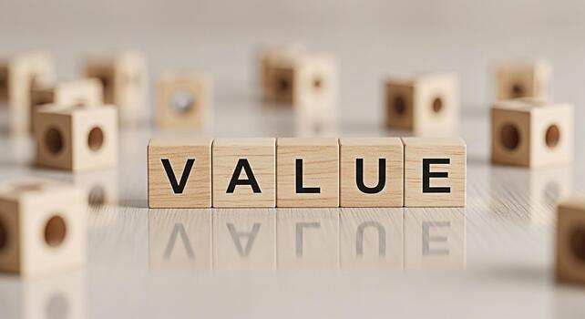 Wooden blocks spelling VALUE on a reflective surface surrounded by other blocks symbolizing importance and worth in a business or personal finance context conveying a sense of stability and investment photo
