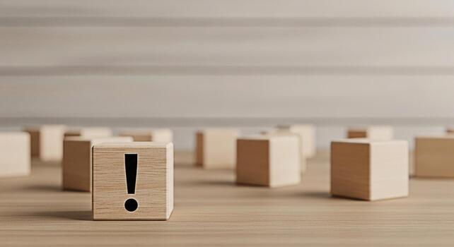 Wooden block displaying an exclamation mark standing out on a wooden surface conveying a sense of urgency and importance in a minimalist and clean environment emphasizing attention to detail photo