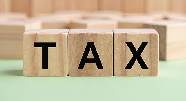 Wooden blocks spelling out TAX on a light green surface representing financial obligations and fiscal responsibility creating a sense of order and precision in managing finances and understanding tax photo